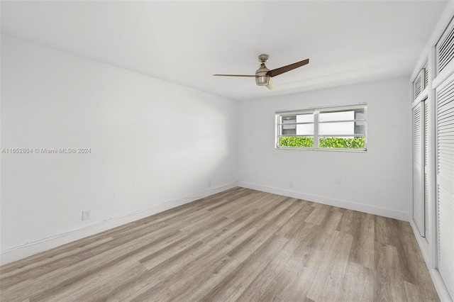 unfurnished bedroom featuring ceiling fan, a closet, and light hardwood / wood-style floors