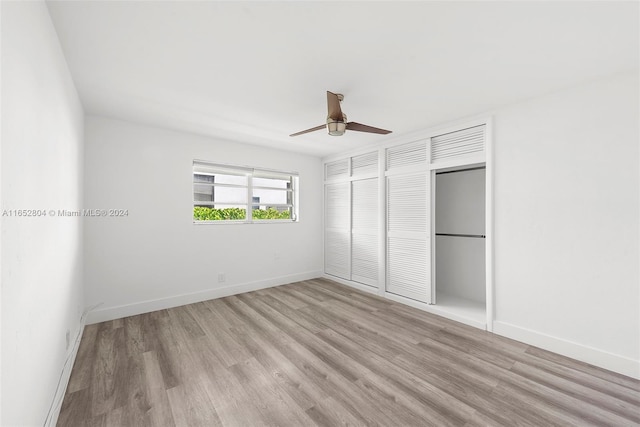 unfurnished bedroom with ceiling fan and light wood-type flooring