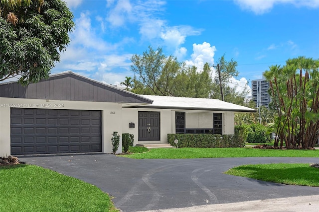 single story home featuring a garage and a front yard