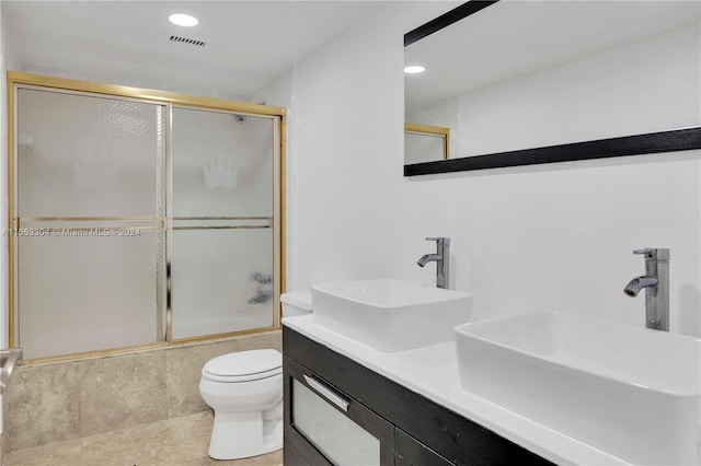 full bathroom featuring combined bath / shower with glass door, vanity, toilet, and tile patterned flooring