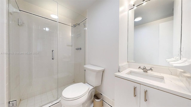 bathroom featuring vanity, toilet, and an enclosed shower