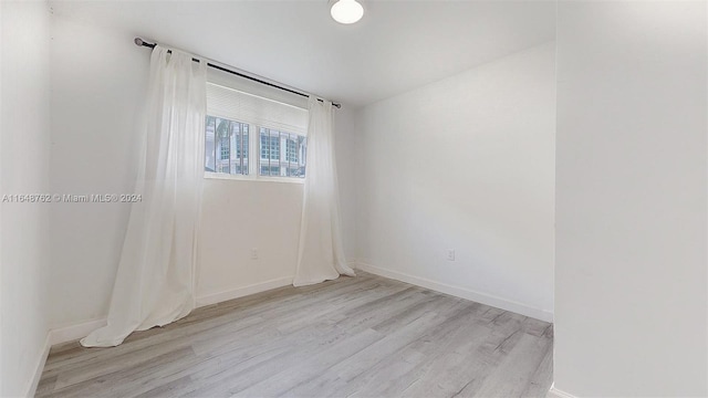 unfurnished room featuring light hardwood / wood-style floors