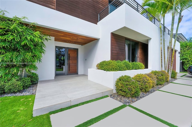 doorway to property with stucco siding