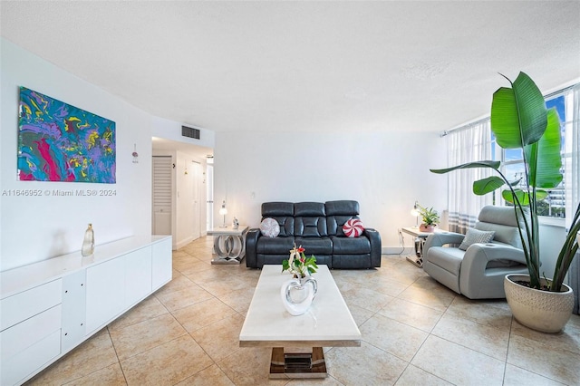 tiled living room with a textured ceiling