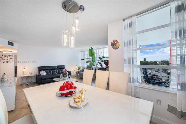 dining area featuring light tile patterned flooring