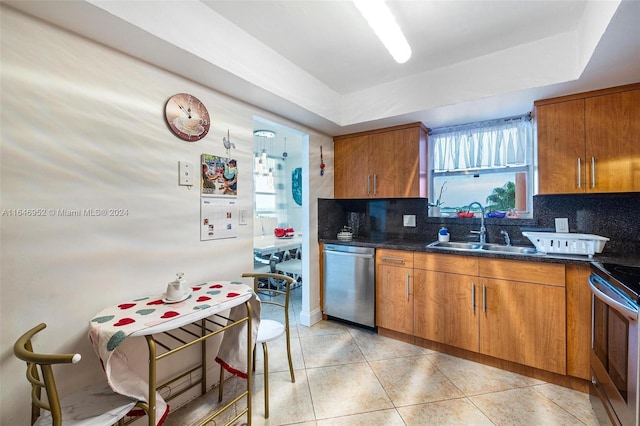 kitchen with plenty of natural light, sink, light tile patterned floors, and appliances with stainless steel finishes