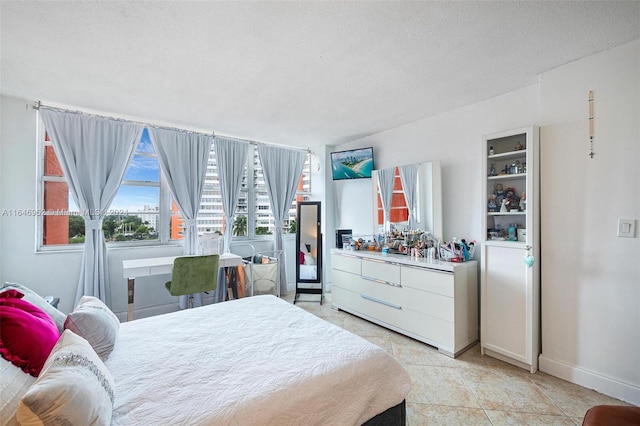 tiled bedroom featuring a textured ceiling