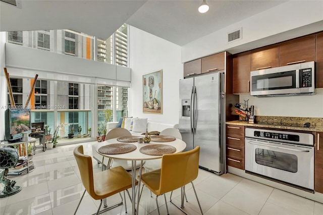 kitchen featuring light tile patterned floors and stainless steel appliances