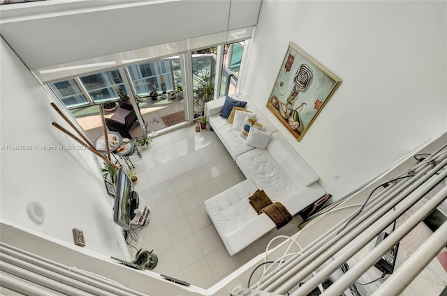 tiled living room featuring a towering ceiling