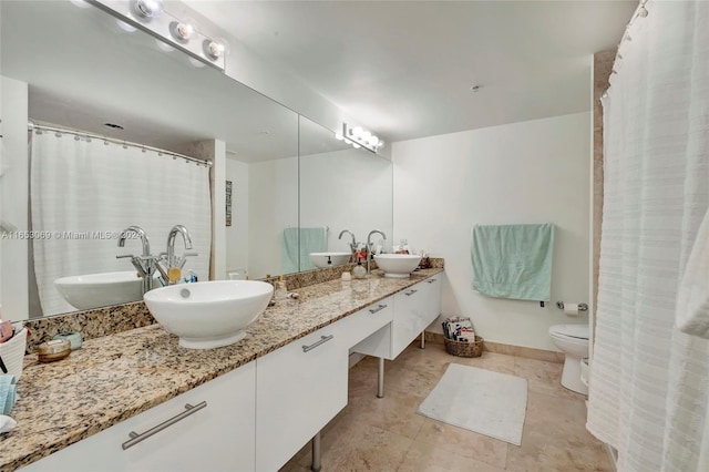 bathroom featuring toilet and vanity