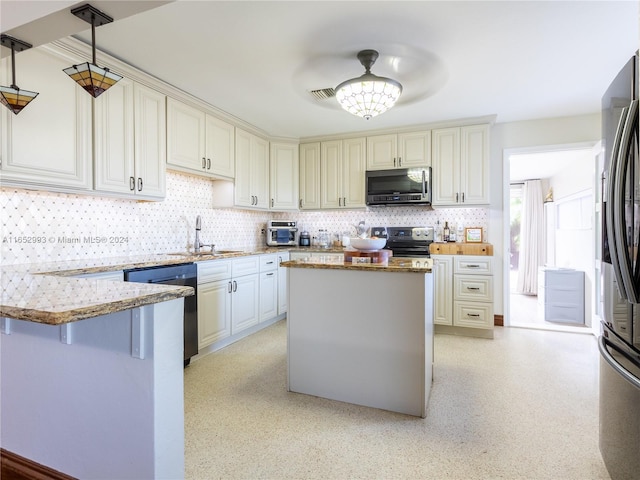 kitchen with light stone countertops, appliances with stainless steel finishes, tasteful backsplash, hanging light fixtures, and sink