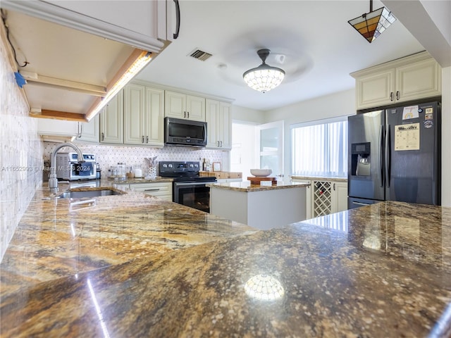 kitchen with a kitchen island, stone countertops, tasteful backsplash, stainless steel appliances, and sink