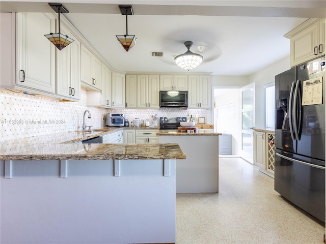 kitchen featuring fridge with ice dispenser, hanging light fixtures, kitchen peninsula, sink, and stone counters