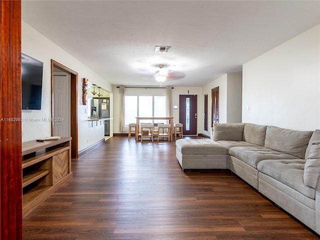 living room with ceiling fan and dark hardwood / wood-style floors