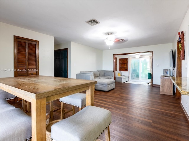 living room with dark hardwood / wood-style flooring and ceiling fan