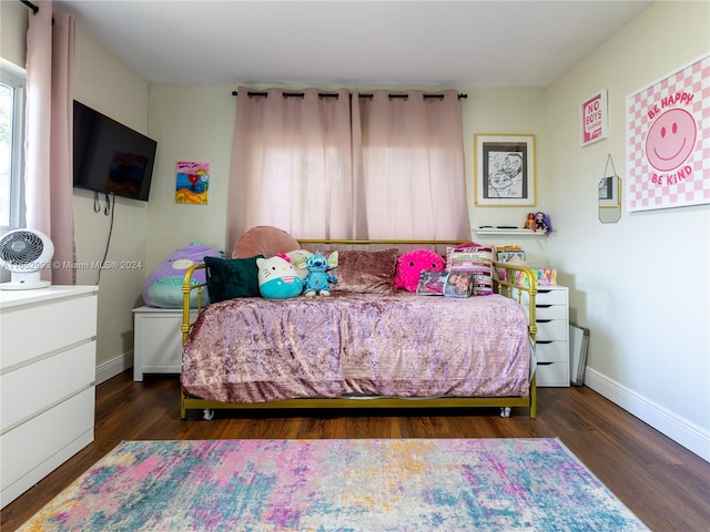 bedroom with dark hardwood / wood-style flooring