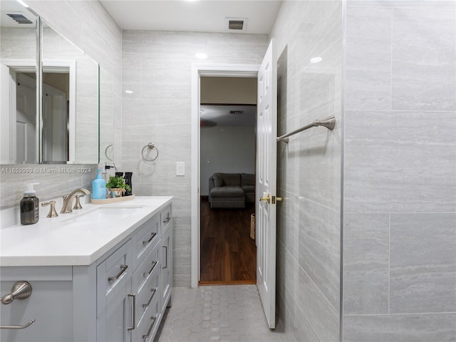 bathroom with vanity, tile walls, and hardwood / wood-style floors