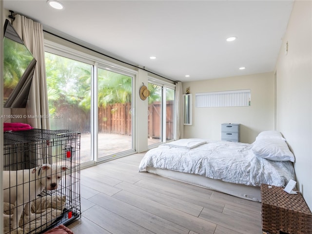 bedroom featuring access to exterior and light wood-type flooring