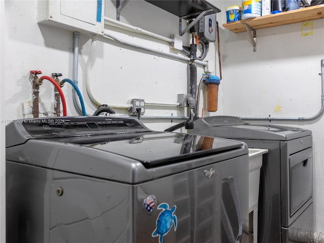 clothes washing area with separate washer and dryer