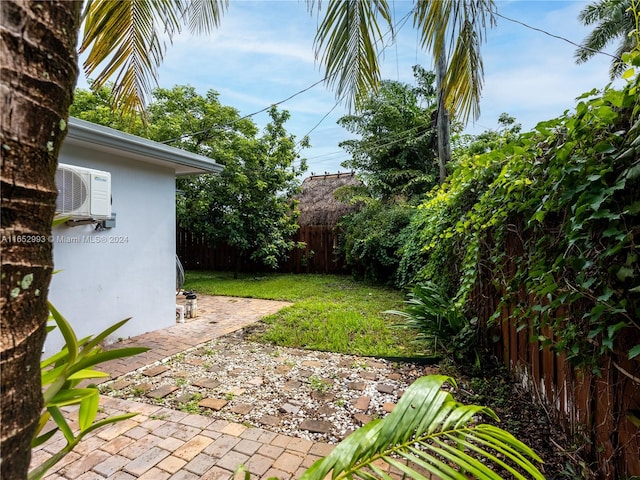 view of yard featuring ac unit and a patio