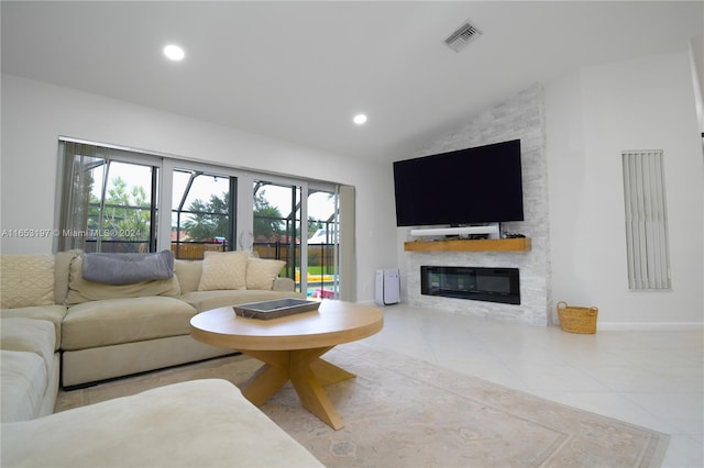 tiled living room featuring vaulted ceiling and a fireplace