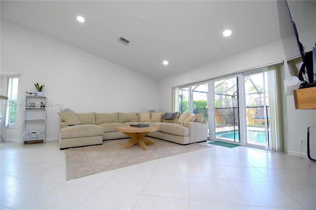 unfurnished living room featuring light tile patterned flooring and vaulted ceiling