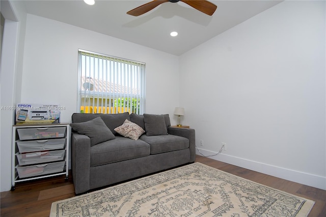 living room with dark hardwood / wood-style flooring, vaulted ceiling, and ceiling fan