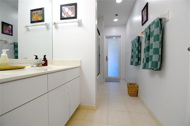 bathroom featuring vanity, tile patterned flooring, and shower / bath combination with glass door