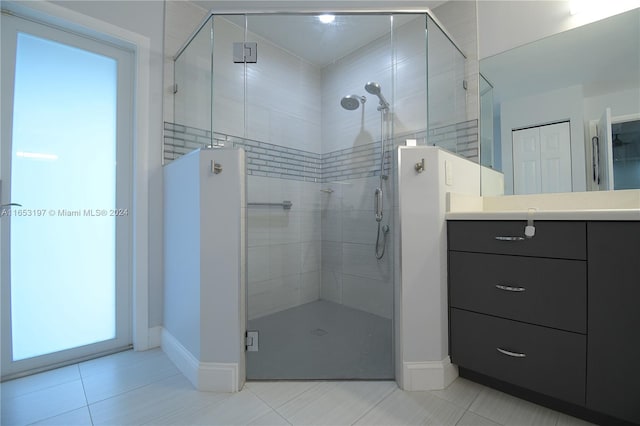 bathroom with vanity, tile patterned floors, and a shower with shower door