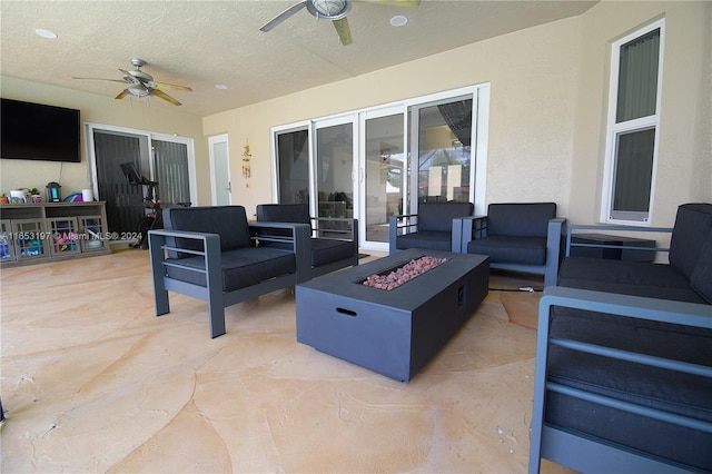 view of patio / terrace with an outdoor living space with a fire pit and ceiling fan