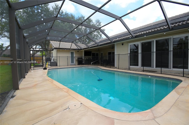 view of pool with a patio area and a lanai