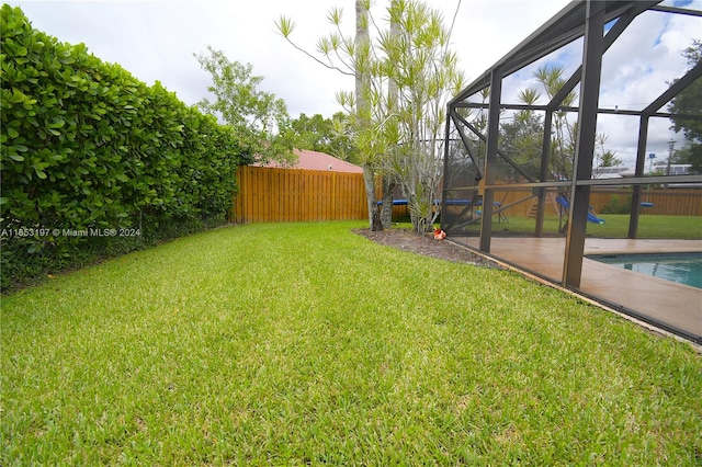 view of yard with glass enclosure