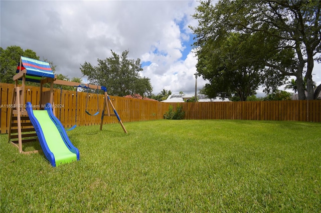 view of jungle gym with a lawn