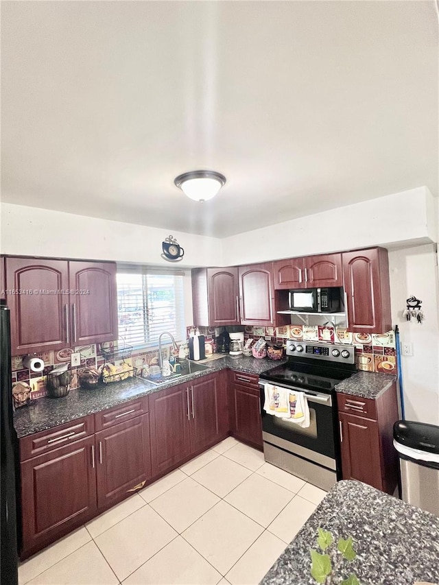 kitchen with black appliances, sink, and light tile patterned flooring