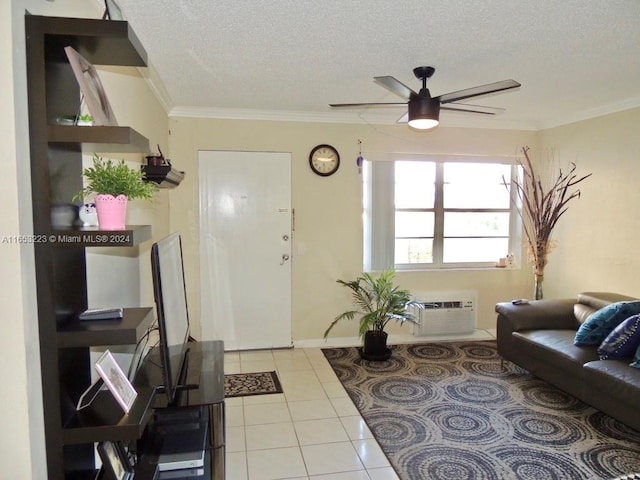 interior space featuring ornamental molding, a textured ceiling, light tile patterned floors, ceiling fan, and an AC wall unit