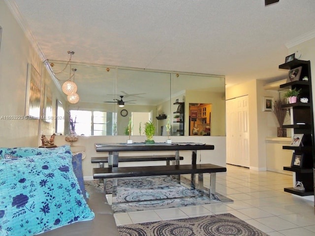 tiled living room featuring crown molding, a textured ceiling, and ceiling fan