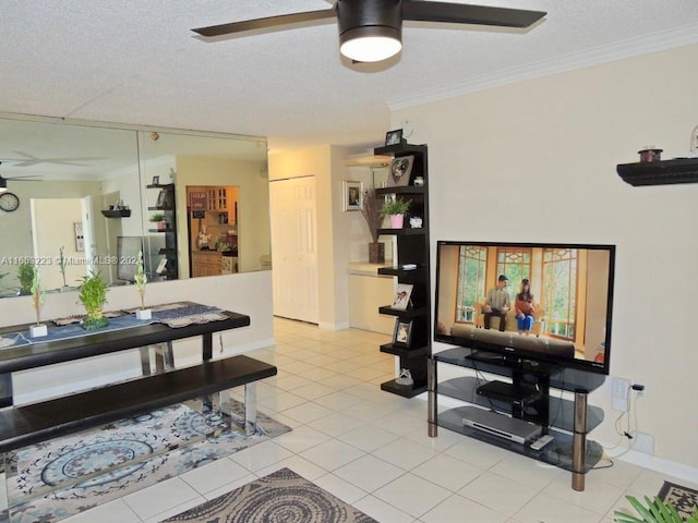 tiled living room featuring ceiling fan, a textured ceiling, and ornamental molding