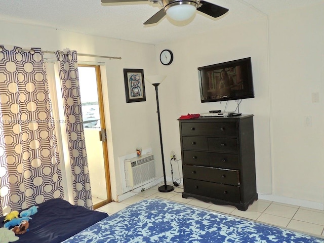 tiled bedroom featuring ceiling fan and a wall mounted air conditioner