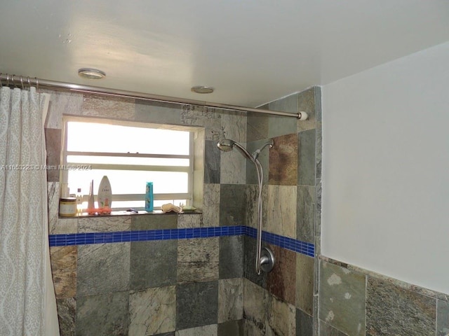 bathroom with tile walls and tiled shower