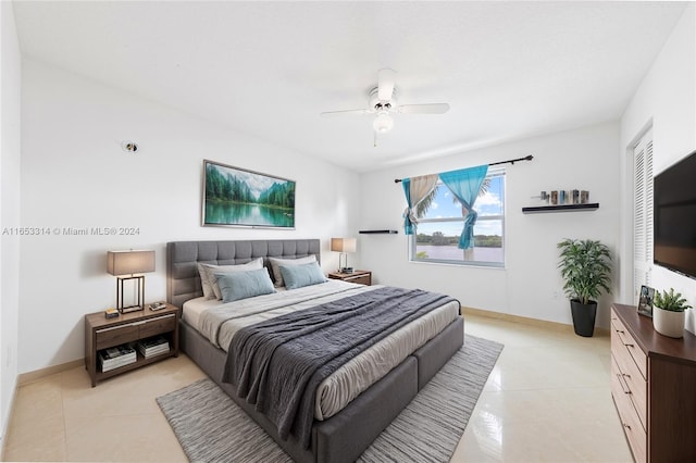 bedroom with ceiling fan, light tile patterned flooring, and a closet