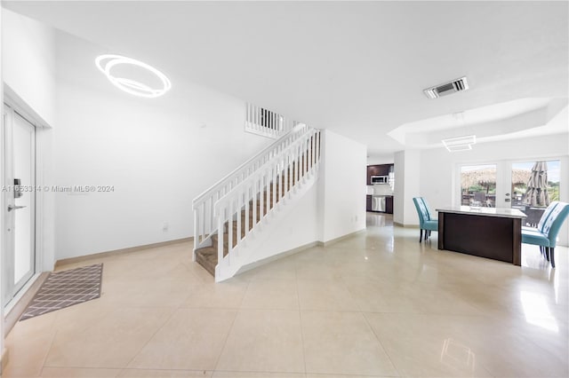 stairway with french doors and tile patterned floors