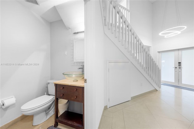 bathroom with vanity, tile patterned flooring, and toilet