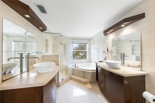 bathroom featuring tile patterned flooring, separate shower and tub, and vanity