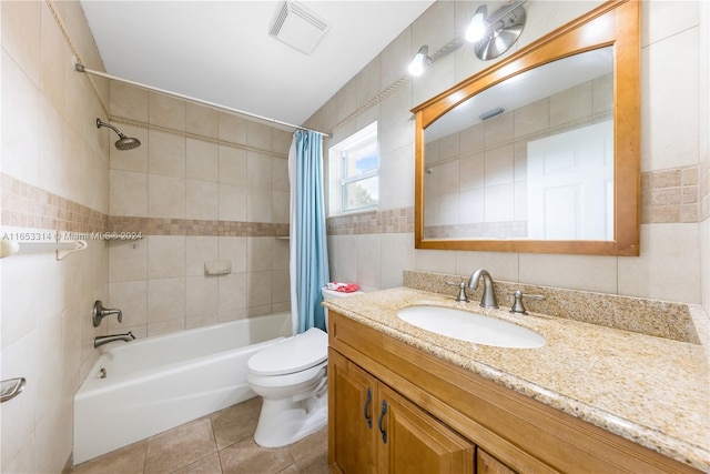 full bathroom with tile patterned flooring, toilet, shower / bathtub combination with curtain, tile walls, and vanity