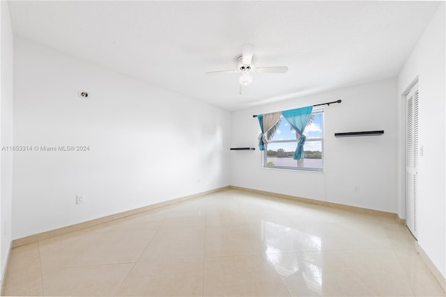 spare room featuring light tile patterned floors and ceiling fan