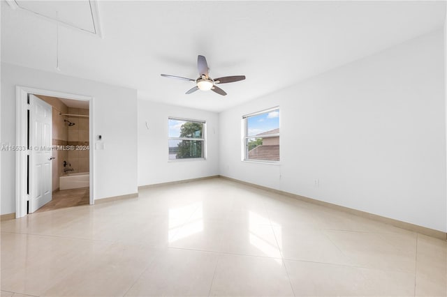 spare room with light tile patterned floors and ceiling fan