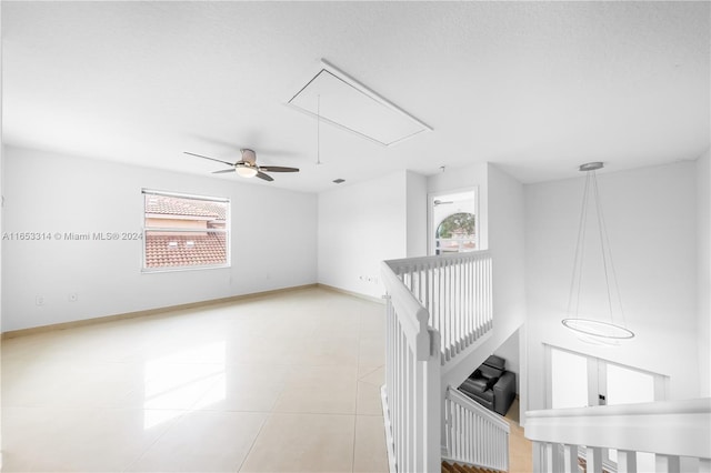 interior space with a textured ceiling and light tile patterned floors