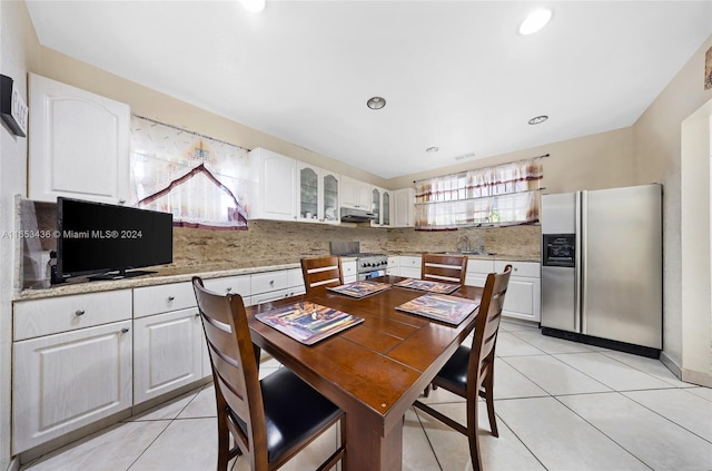 tiled dining room featuring sink