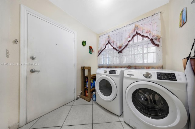 clothes washing area featuring light tile patterned floors and washing machine and clothes dryer