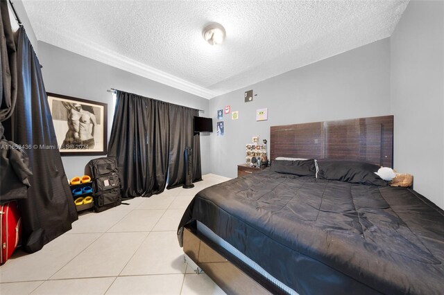 tiled bedroom with a textured ceiling